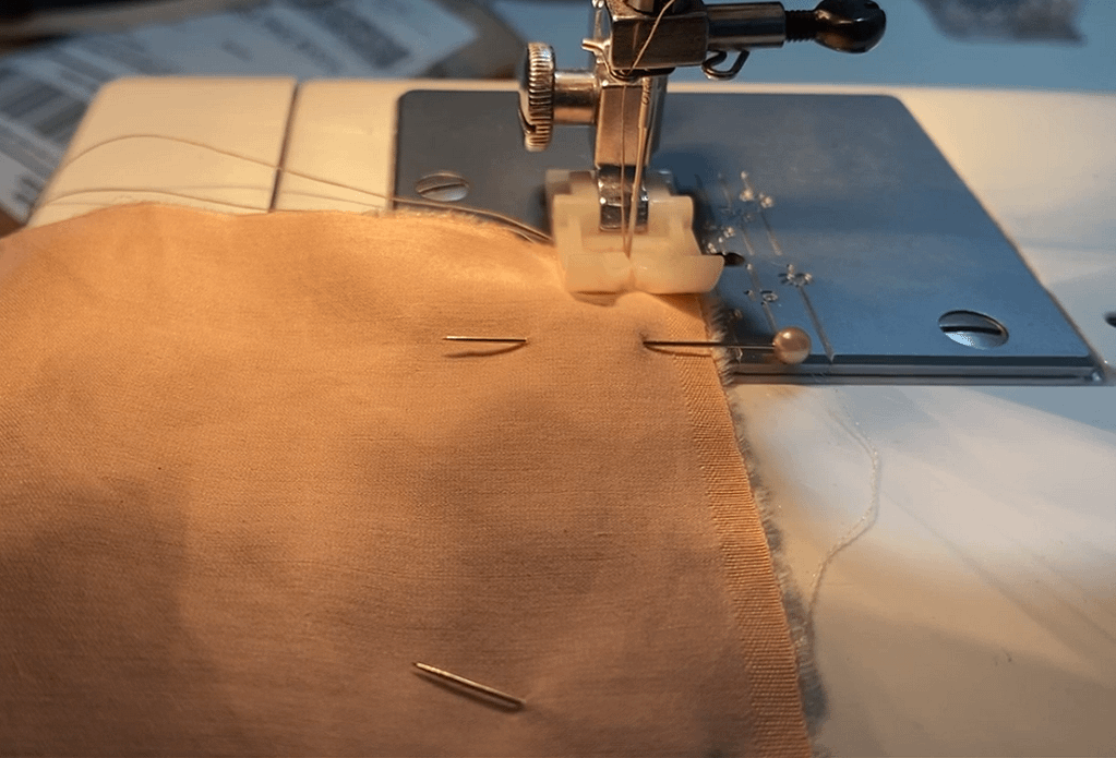 strip of fabric in sewing machine and pins