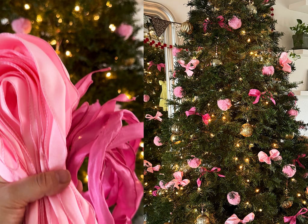 hand holding pink ribbon and green christamas tree with pink bows and pink faux fur pom pops