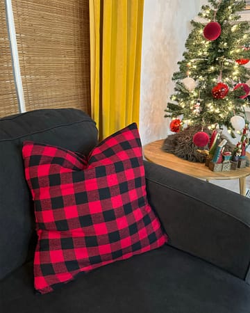 red checkered pillow on black couch