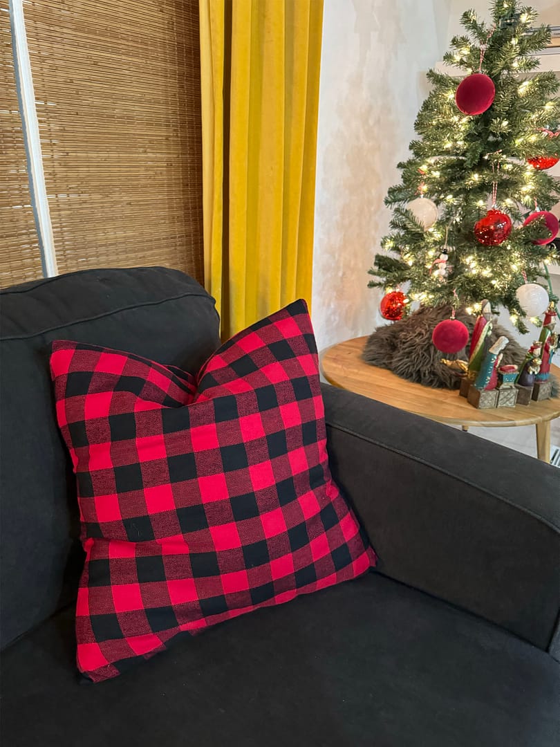 red checkered pillow on black couch